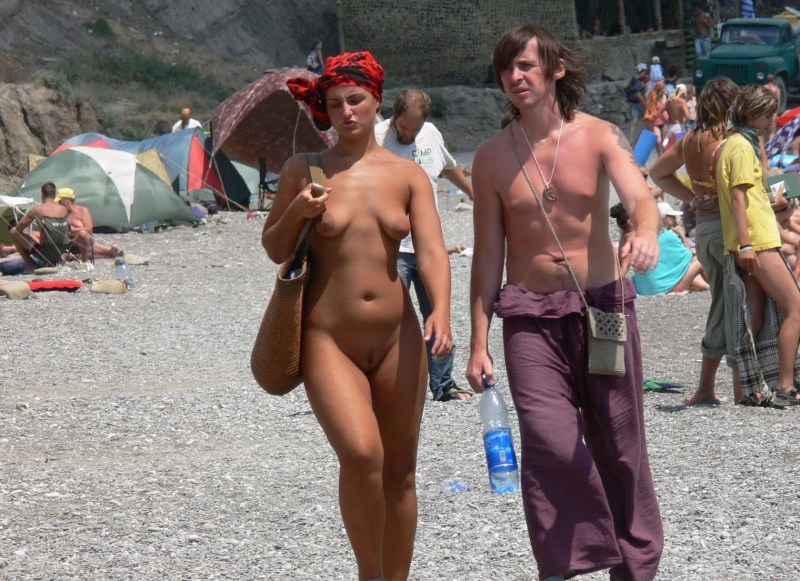 Naked on the beach among dressed