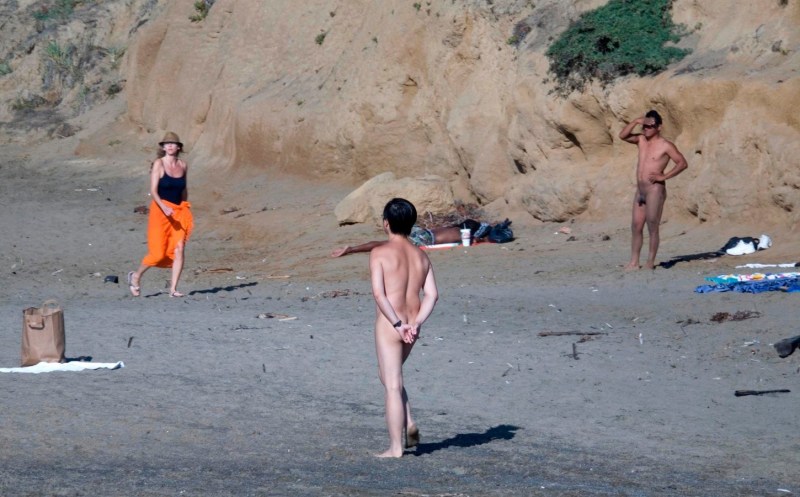 Naked on the beach among dressed